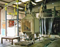 Bulk bag discharge system installed at Omex Agrifluids includes bag frame (upper left), Flow-Flexer(TM) plates, hopper chute, and conveyor at rear that transports material to the blender. 