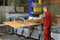 The vacuum tube lifter JumboErgo 110 being used for ergonomic and precise loading of a CNC machine tool.